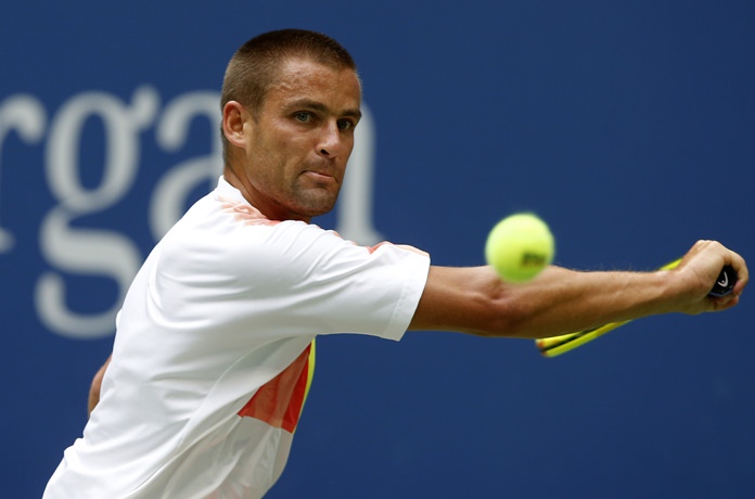 Mikhail Youzhny of Russia returns a shot to Novak Djokovic of Serbia during the third round of the U.S. Open tennis tournament Friday Sept. 2 in New York