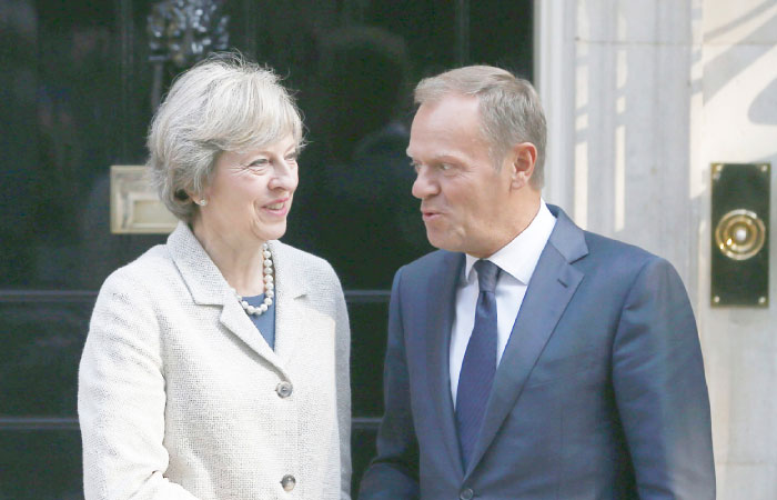 Britain’s Prime Minister Theresa May left greets European Council President Donald Tusk in Downing Street in London on Thursday. — Reuters