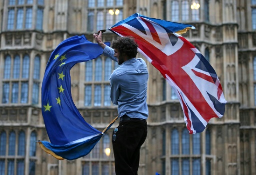 A man waves a British flag and a European flag at an anti Brexit protest in central London