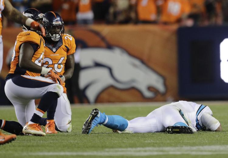 Cam Newton lies on the turf after a roughing the passer penalty on Denver Broncos free safety Darian Stewart during the Panthers final drive on Thursday night