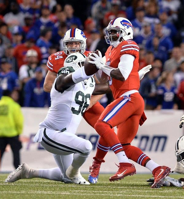 Buffalo Bills quarterback Tyrod Taylor looks to pass under pressure from New York Jets defensive end Muhammad Wilkerson during the first half of an NFL football game Thursday Sept. 15 2016 in Orchard Park N.Y