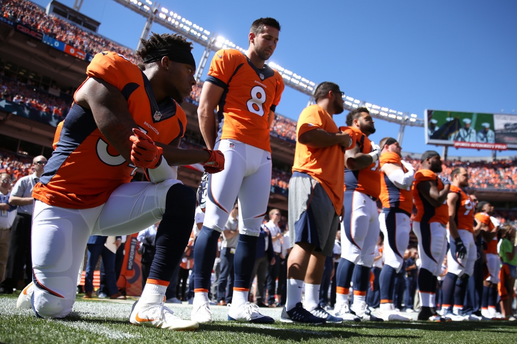 Inside linebacker Brandon Marshall of the Broncos takes a knee during the National Anthem before the game against the Indianapolis Colts at Sports Authority Field Field at Mile High