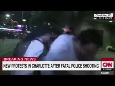 CNN's Ed Lavandera is pushed to the ground during a live report on the Charlotte N.C. police-shooting protests