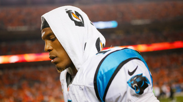 Quarterback Cam Newton #1 of the Carolina Panthers walks off the field after losing to the Broncos 21-20 at Sports Authority Field at Mile High