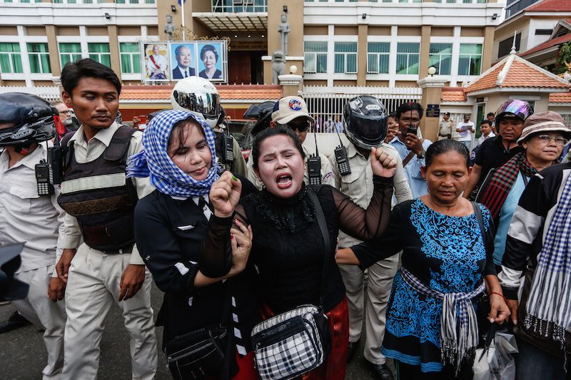 Activist Bo Chhorvy center shouts outside the Phnom Penh Municipal Court on Monday morning after being sentenced to six months in prison