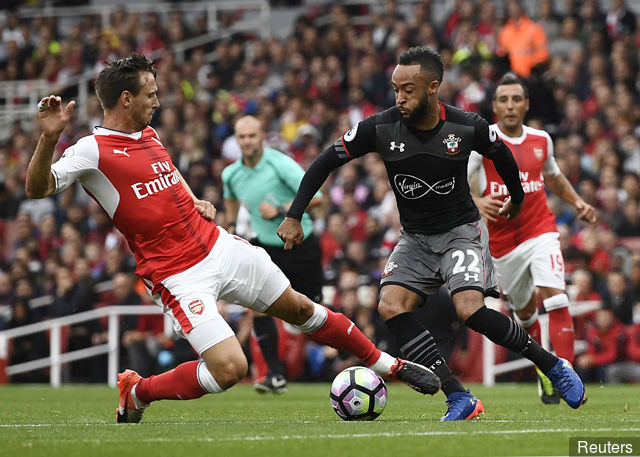 Southampton's Nathan Redmond is fouled by Arsenal's Nacho Monreal resulting in a yellow card