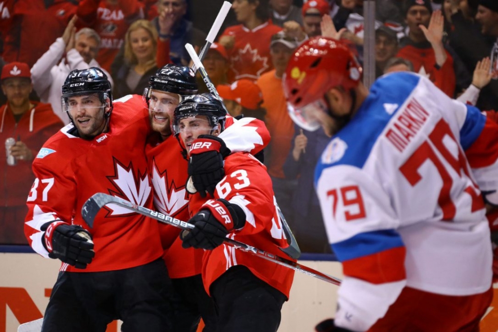 Canadians Brad Marchand Patrice Bergeron and Alex Pietrangelo celebrate while Russia's Andrei Markov skates by in the second period of Saturday night's World Cup semifinal at the ACC