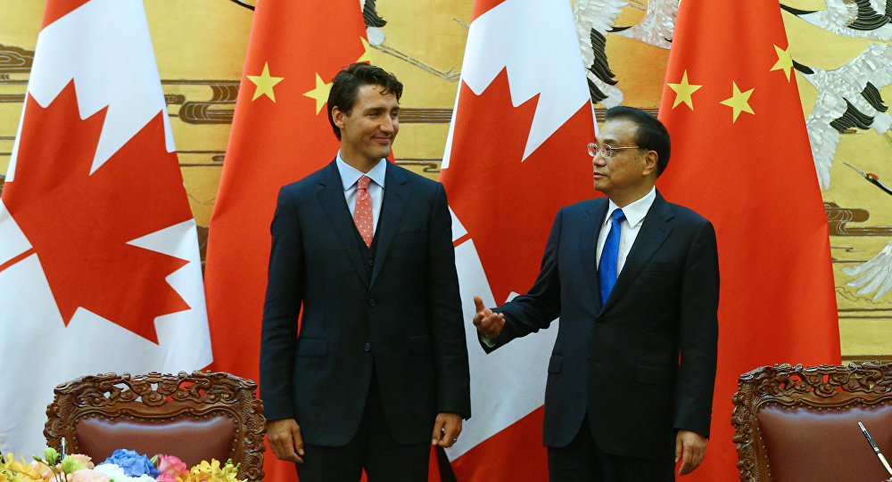 Chinese Premier Li Keqiang and Canadian Premier Justin Trudeau talk as they attend the ceremony of sign agreement documents after a meeting at the Great Hall of the People in Beijing China 31 August 2016