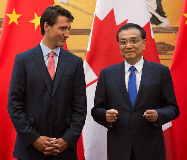 Canadian Prime Minister Justin Trudeau speaks with Premier of the People's Republic of China Li Keqiang before a signing ceremony at the Great Hall of the People in Beijing China on Wednesday