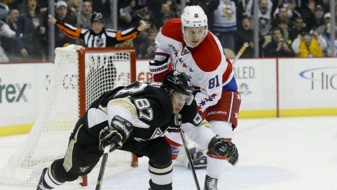 Pittsburgh Penguins’ Sidney Crosby and Washington Capitals’ Dmitry Orlov chase the puck during the second period of an NHL game on Tuesday in Pittsburgh