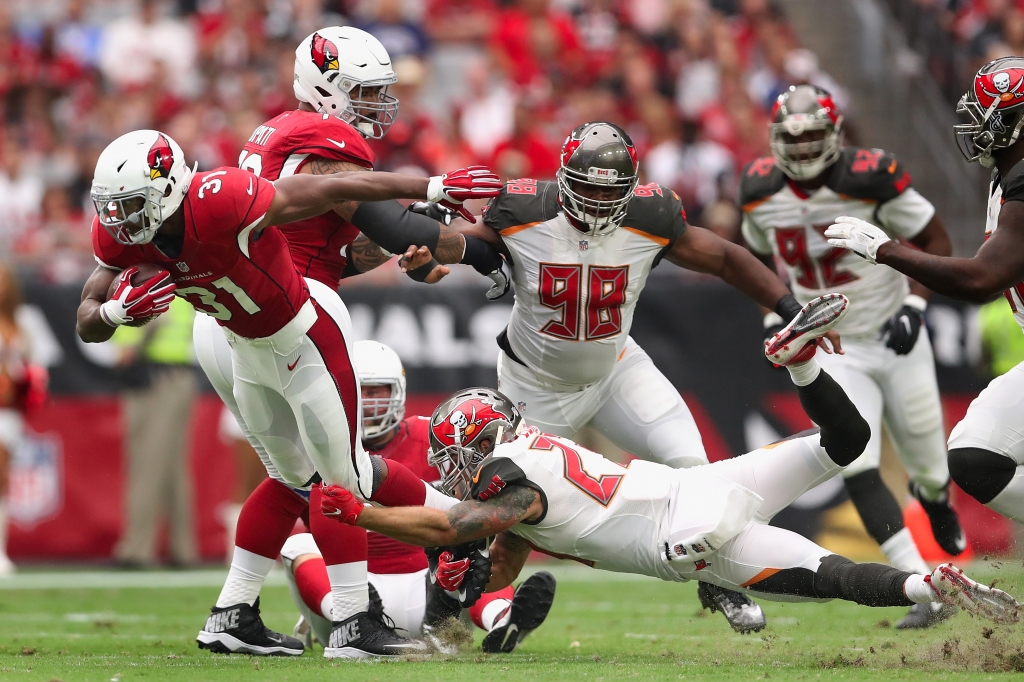 GLENDALE AZ- SEPTEMBER 18 Running back David Johnson #31 of the Arizona Cardinals rushes the football past strong safety Chris Conte #23 of the Tampa Bay Buccaneers during the second quarter of the NFL game at the University of Phoenix Stadium on Sept