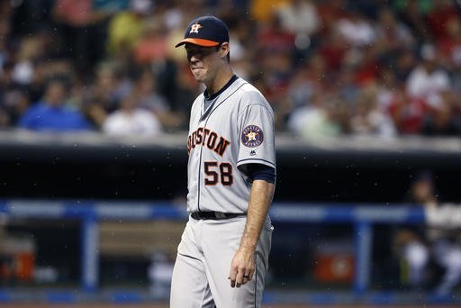 Houston Astros starting pitcher Doug Fister walks off the field through a swarm of bugs after being pulled during the fifth inning of a baseball game against the Cleveland Indians on Wednesday Sept. 7 2016 in Cleveland