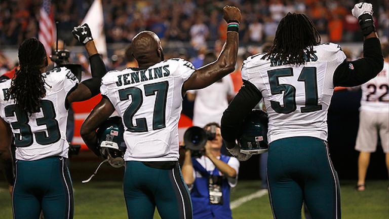 Eagles players raise fists in protest during national anthem