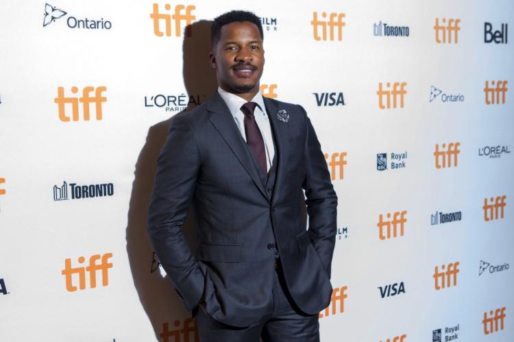 Director Nate Parker poses as he arrives on the red carpet for the film ‘Birth of a Nation’ during the 2016 Toronto International Film Festival Friday