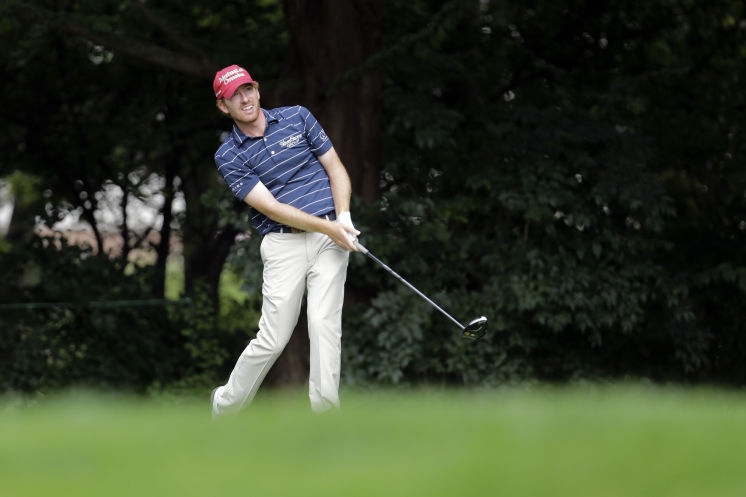 Roberto Castro watches his shot from the second tee during the first round of the BMW Championship at Crooked Stick Golf Club in Carmel Ind. He finishes atop the leaderboard at 7-under 65 but nearly half the field did not complete the round because of