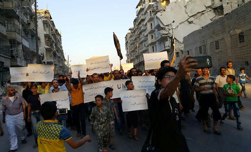 Activists in Syria’s besieged Aleppo protest against the United Nations for what they say is its failure to lift the siege off their rebel-held area Tuesday Sept. 13 2016. Dozens of protesters marched in al Shaar neighborhood