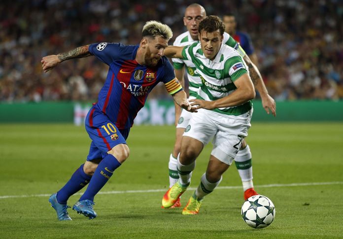 Barcelona's Lionel Messi left takes on Celtic's Erik Sviatchenko during their Champions League Group C match at the Camp Nou stadium in Barcelona Spain Tuesday Sept. 13