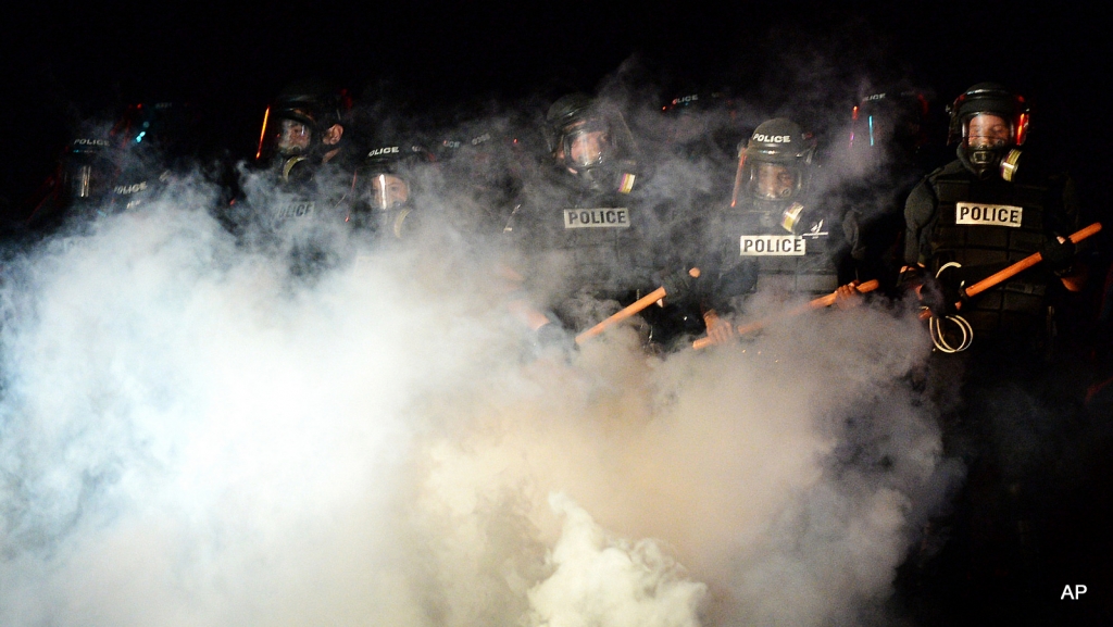 Police stand in formation in Charlotte N.C. Tuesday Sept. 20 2016. Authorities used tear gas to disperse protesters in an overnight demonstration that broke out Tuesday after Keith Lamont Scott was fatally shot by an officer at an apartment complex