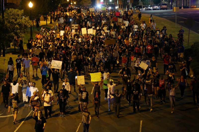 Demonstrators march outside the downtown streets protesting the police shooting of Keith Scott in Charlotte