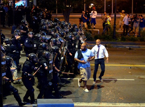 Charlotte-Mecklenburg police officers begin to push protesters from the intersection near the Epicentre in Charlotte N.C. Wednesday Sept. 21 2016. Authorities in Charlotte tried to quell public anger Wednesday after a police officer shot a black man