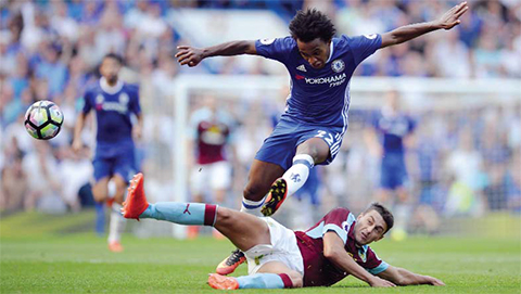 LONDON Chelsea’s Brazilian midfielder Willian jumps a tackle during the English Premier League football match between Chelsea and Burnley at Stamford Bridge in London yesterday. — AFP