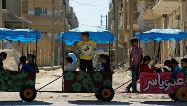 Children ride in carts on the third day of Eid al Adha in the rebel-controlled city of Idlib Syria Sept. 14 2016