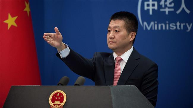 Chinese Foreign Ministry spokesman Lu Kang takes a question from the media during a press conference in Beijing