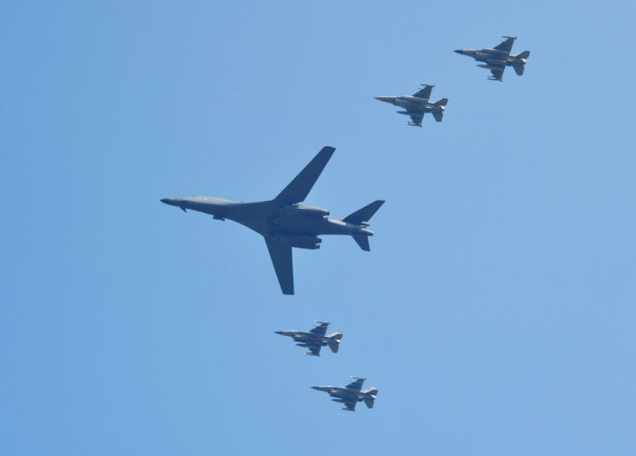 A US B-1B Lancer center is escorted by US F-16 fighter jets as it flies over the Osan Air Base aiming at reinforcing the US commitment to its key ally in Pyeongtaek South Korea on Tuesday. — AFP