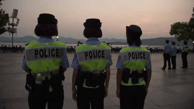 Police officers secure an area in Hangzhou China. Factories have been closed to ensure blue skies potential troublemakers detained and a quarter of the residents have left after being offered 'vacation vouchers,&#39 all to make sure the city will