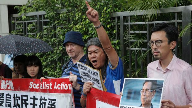 Radical pro-democracy politican Leung Kwok-hung second from right and other protesters holding