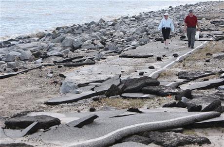 Lee and Gary Moulton walk from their home along what is left of a road that was destroyed by Hurricane Hermine in the Alligator Point community of Franklin County Fla. Friday Sept. 2 2016