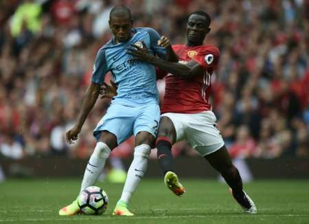 Manchester City's Fernandinho fights for the ball with Manchester United's Eric Bailly during their English Premier League match at Old Trafford