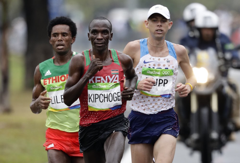 Eliud Kipchoge of Kenya leads Feyisa Lilesa of Ethiopia and Galen Rupp of the U.S. late in the marathon before pulling away to win in a time of 2 hours 8 minutes 44 seconds. Lilesa took the silver medal and Rupp won bronze.
Associated Press  Robert F. Bu