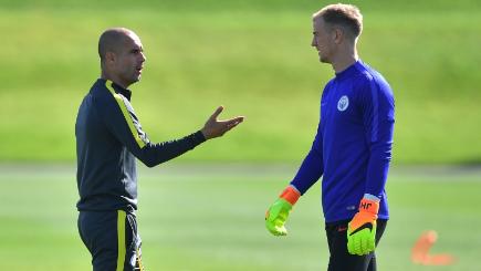 Manchester City manager Pep Guardiola left spoke to goalkeeper Joe Hart during training