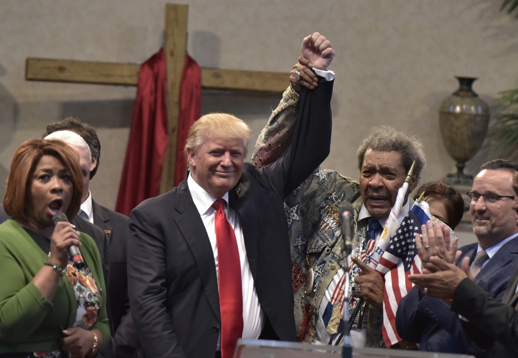 Boxing promoter Don King raises the arm of Republican presidential nominee Donald Trump during the Midwest Vision and Values Pastors and Leadership Conference at the New Spirit Revival Center in Cleveland Heights Ohio