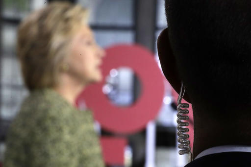 A Secret Service agent stands guard as Democratic presidential candidate Hillary Clinton speaks during a campaign stop at Temple University in Philadelphia Monday Sept. 19 2016