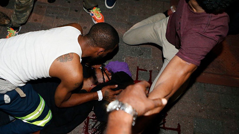 CHARLOTTE NC- SEPTEMBER 21 Protesters tend to a seriously wounded protester in the parking area of the the Omni Hotel during a march to protest the death of Keith Scott