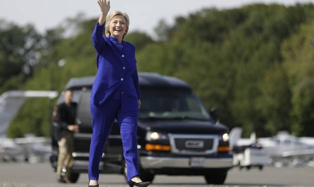 Democratic presidential candidate Hillary Clinton waves as she walks to her campaign plane at Westchester County Airport in White Plains N.Y. Wednesday Sept. 21 2016