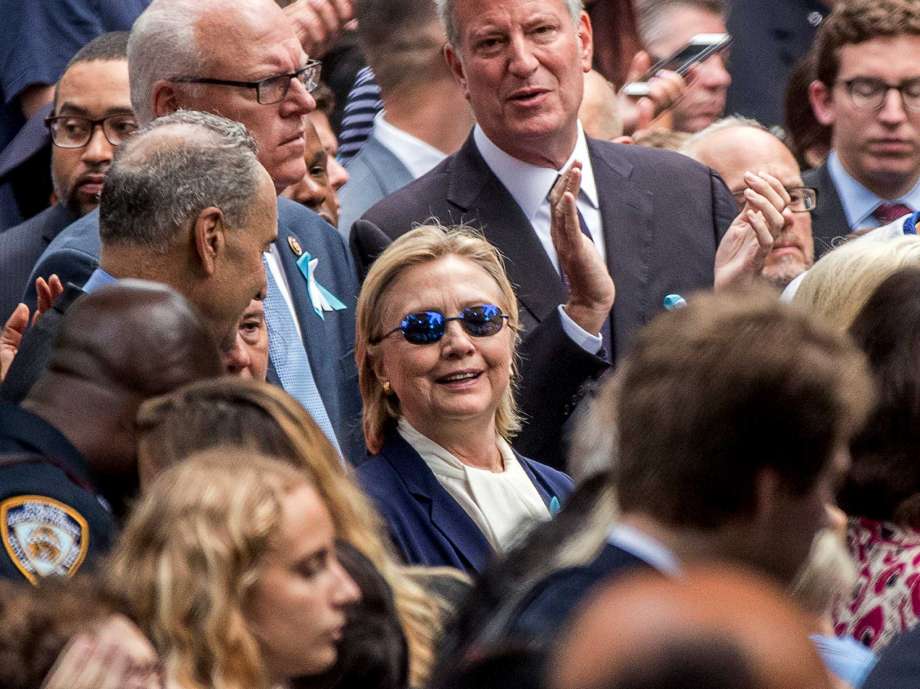 Democratic presidential candidate Hillary Clinton center accompanied by Sen. Chuck Schumer D-N.Y. left Rep. Joseph Crowley D-N.Y. second from left at top and New York Mayor Bill de Blasio center top attends a cerem