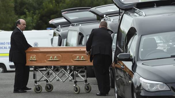 Coffins are taken to hearses at the scene in Oakdene Barconey Ballyjamesduff in Cavan