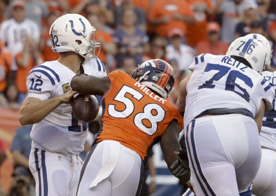 Denver Broncos outside linebacker Von Miller right forces a fumble by Indianapolis Colts quarterback Andrew Luck late in the Broncos&#39 win Sunday in Denver. Broncos linebacker Shane Ray scored on the play