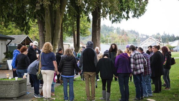 Community members gather in a circle for a group prayer at Maiben Park in Burlington Wash. on Saturday Sept. 24 2016. Lindsey Wasson  AP