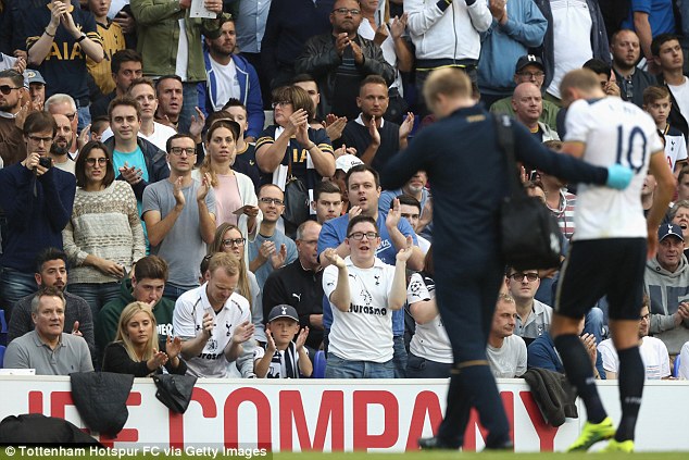 Concerned Tottenham fans look on as they applaud Kane off the pitch on Sunday