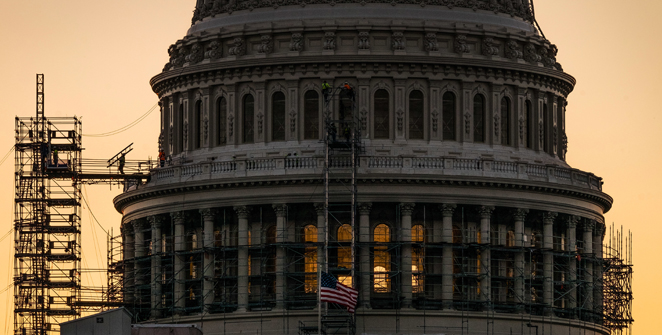 A construction worker carries a ladder across the scaffolding on the U.S. Capitol Dome early in the morning Tuesday Sept. 6 2016 in Washington on the day Congress returns to work after their summer holiday