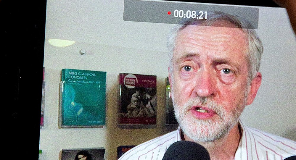 A journalist records British Labour Party leader Jeremy Corbyn on a mobile phone