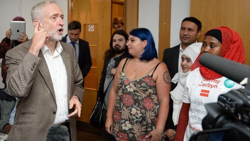 Britain's Labour Party leader Jeremy Corbyn left at a rally for party members phoning people for their support of Corbyn in the leadership election at the Unison headquarters in central London Tuesday Sept. 20 2016