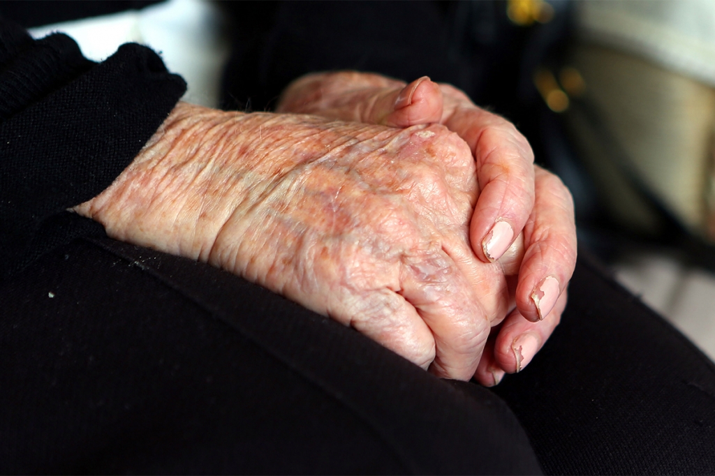 An elderly person's hands