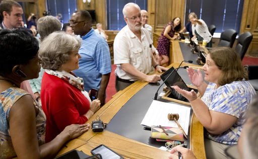 Chairwoman Kathryn Lindley right is approached by people during the Guilford County Board of Elections meeting at the Old Guilford County Courthouse in Greensboro N.C. The swing state of North Carolina could be