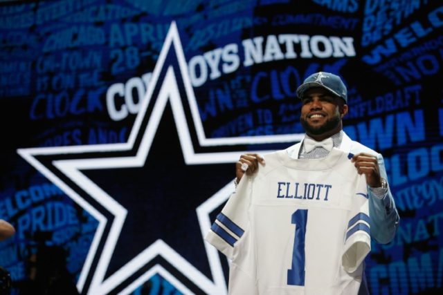 Ezekiel Elliott of Ohio State holds up a jersey after being picked #4 overall by the Dallas Cowboys during the first round of the 2016 NFL Draft