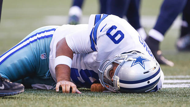 Cowboys quarterback Tony Romo lies on the turf after a tackle against the Seahawks on Aug. 25 in Seattle